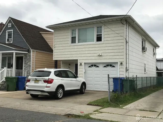 a view of a car parked in front of a house