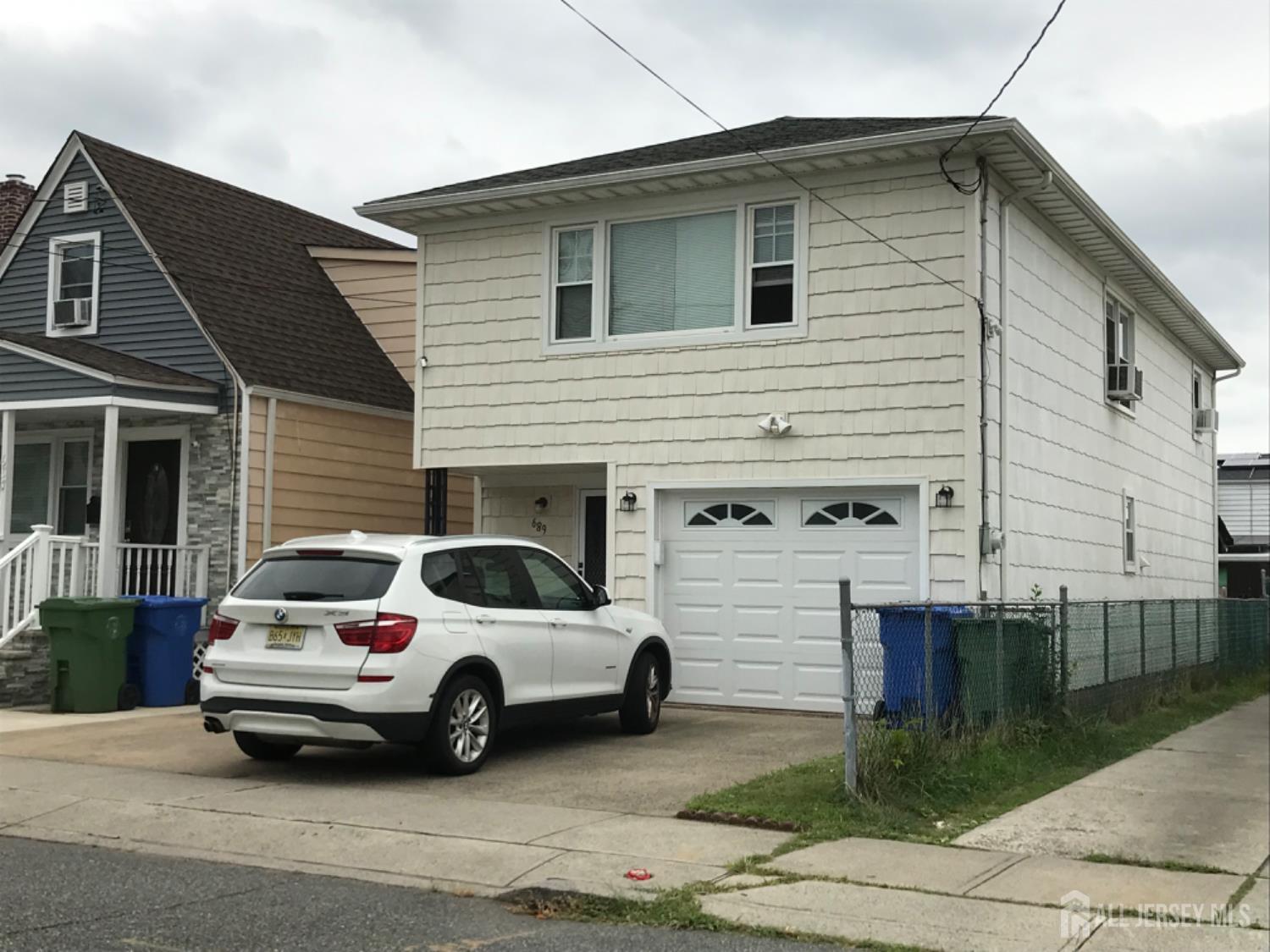 a view of a car parked in front of a house