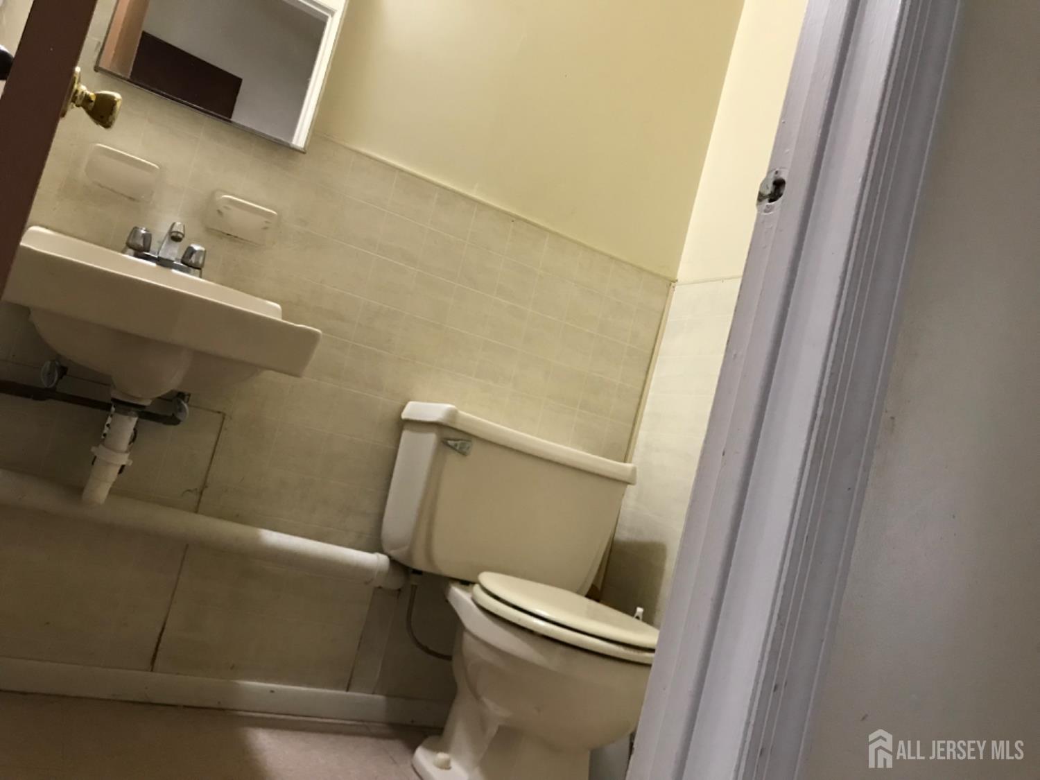 689 Mary Street Perth Amboy, NJ 08861 - Photo 21 of 24 a bathroom with a sink and toilet