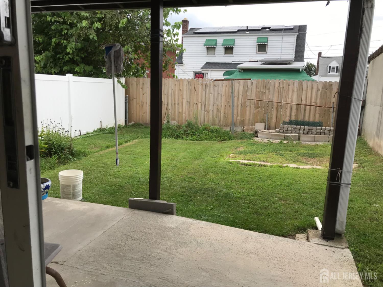 689 Mary Street Perth Amboy, NJ 08861 - Photo 24 of 24 a backyard of a house with table and chairs