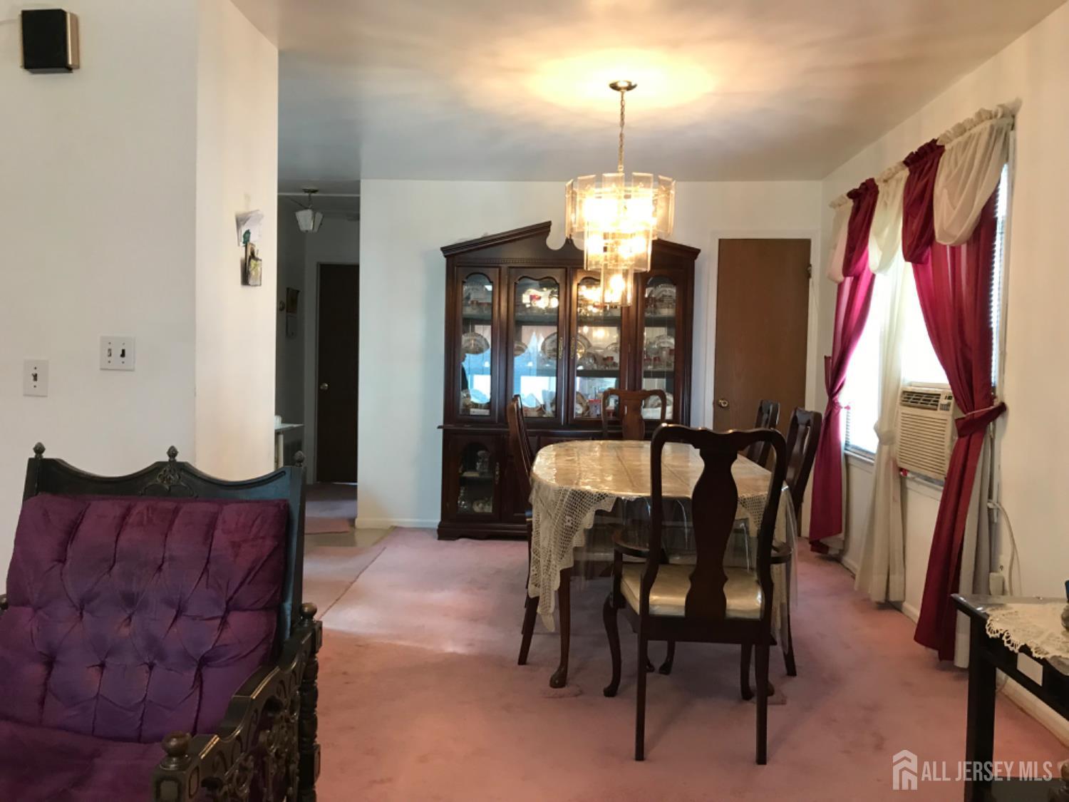 689 Mary Street Perth Amboy, NJ 08861 - Photo 3 of 24 a view of a dining room with furniture and a chandelier