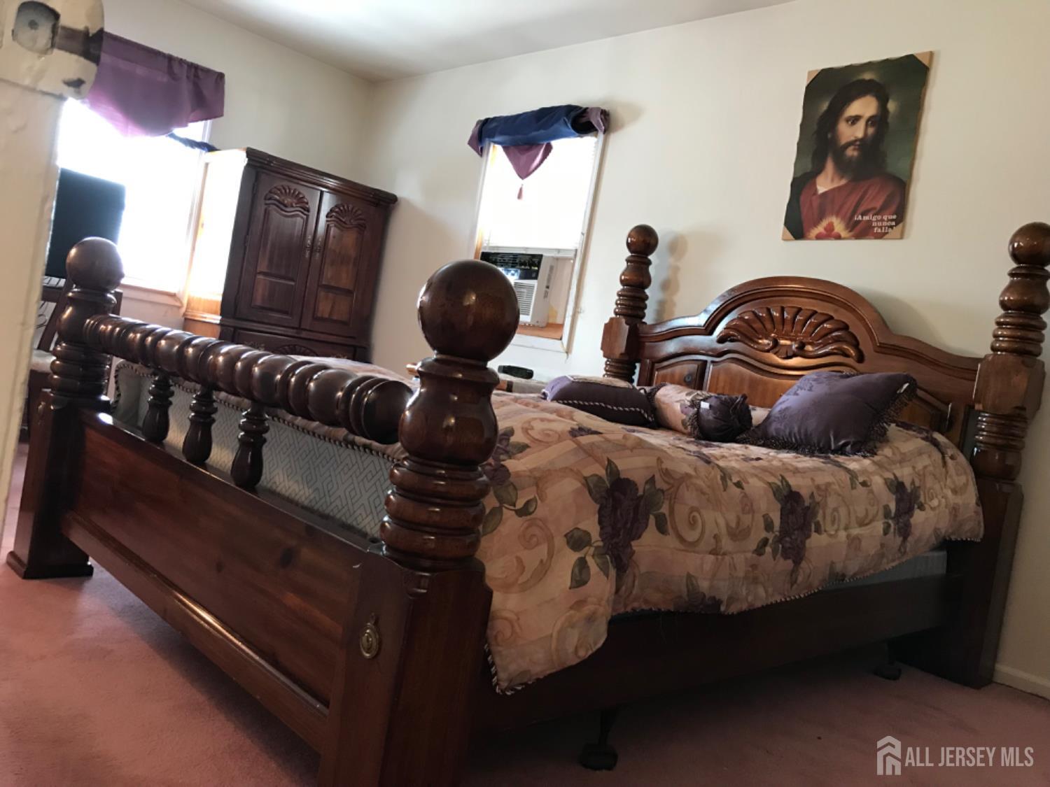 689 Mary Street Perth Amboy, NJ 08861 - Photo 7 of 24 a bed room with a bed and mirror