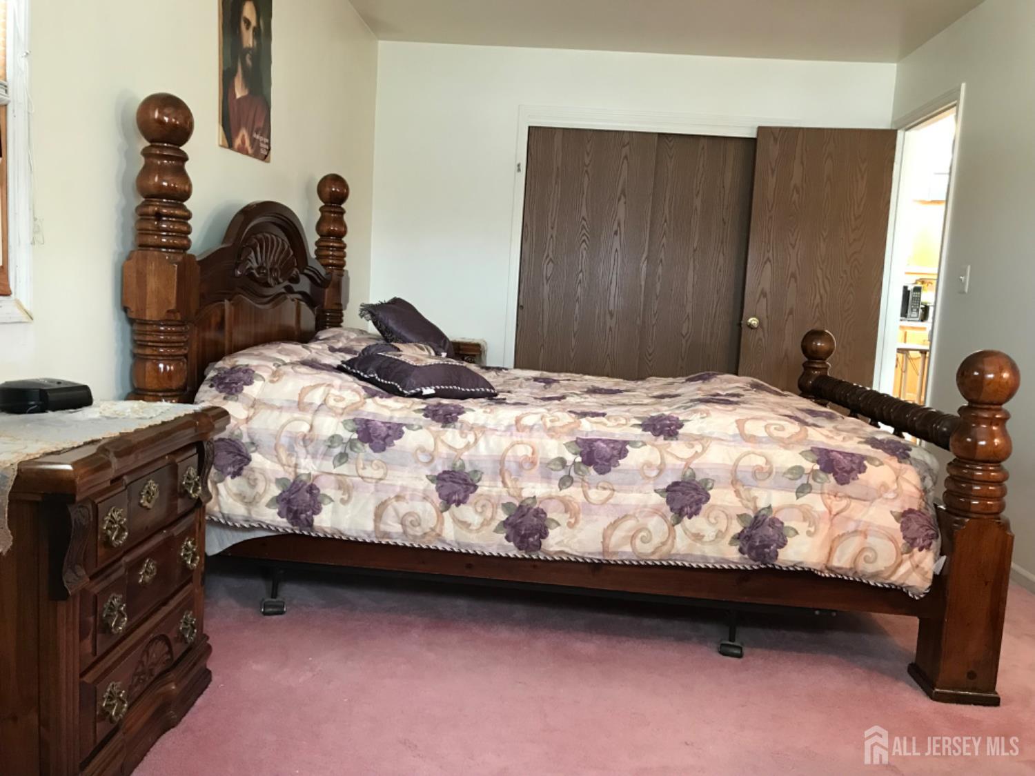 689 Mary Street Perth Amboy, NJ 08861 - Photo 8 of 24 a bedroom with a bed and a dresser