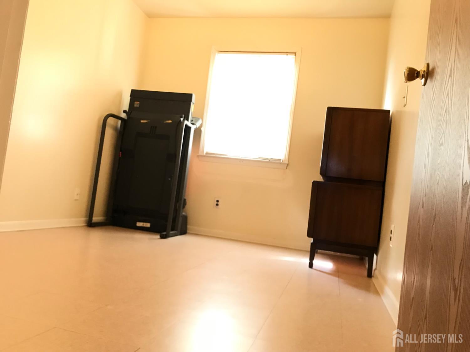 689 Mary Street Perth Amboy, NJ 08861 - Photo 10 of 24 an empty room with a window