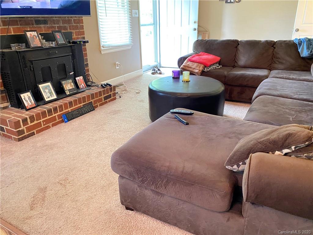 3301 Back Creek Church Road Charlotte, NC 28213 - Photo 13 of 30 a living room with furniture gym equipment and a flat screen tv