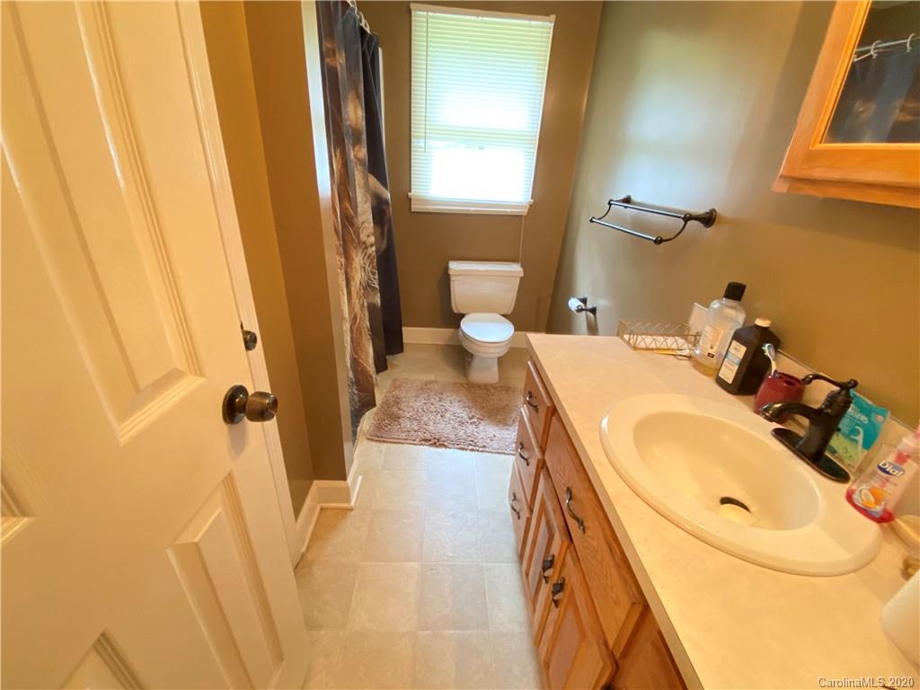 3301 Back Creek Church Road Charlotte, NC 28213 - Photo 18 of 30 a bathroom with a sink and mirror with toilet