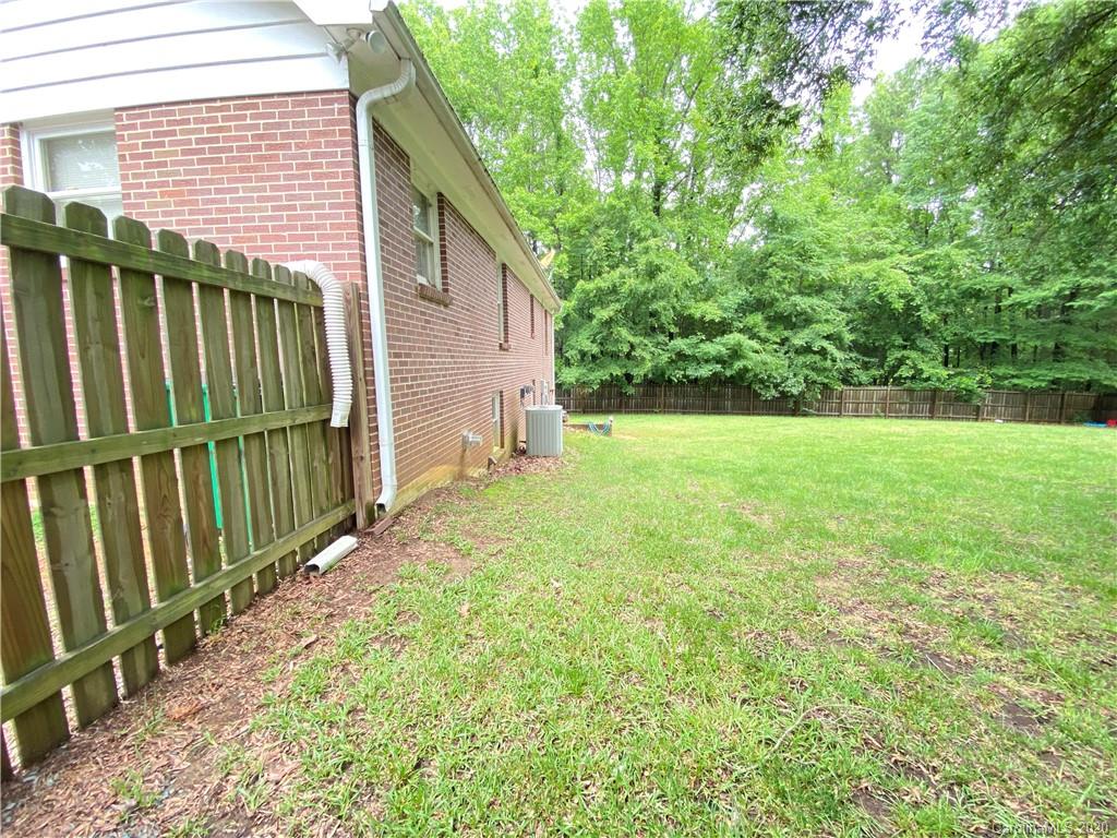 3301 Back Creek Church Road Charlotte, NC 28213 - Photo 22 of 30 a view of a backyard with wooden fence and large trees