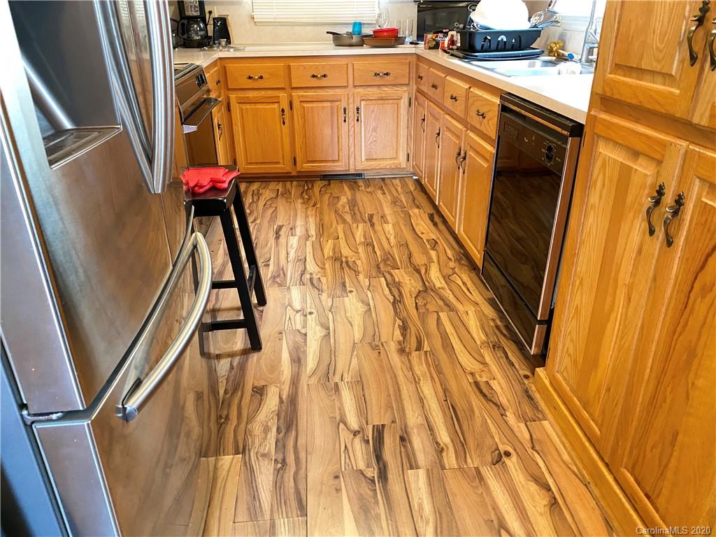 3301 Back Creek Church Road Charlotte, NC 28213 - Photo 9 of 30 a view of a kitchen with wooden floor and staircase