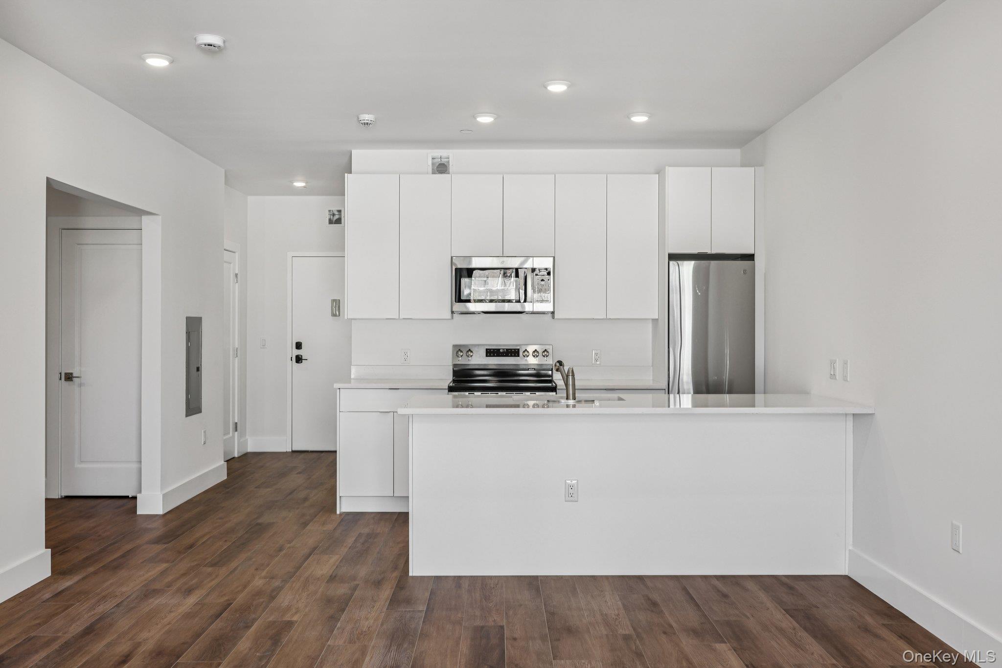 199 East Post Road, Unit 202 White Plains, NY 10601 - Photo 15 of 21 a kitchen with stainless steel appliances granite countertop a refrigerator a stove and a sink