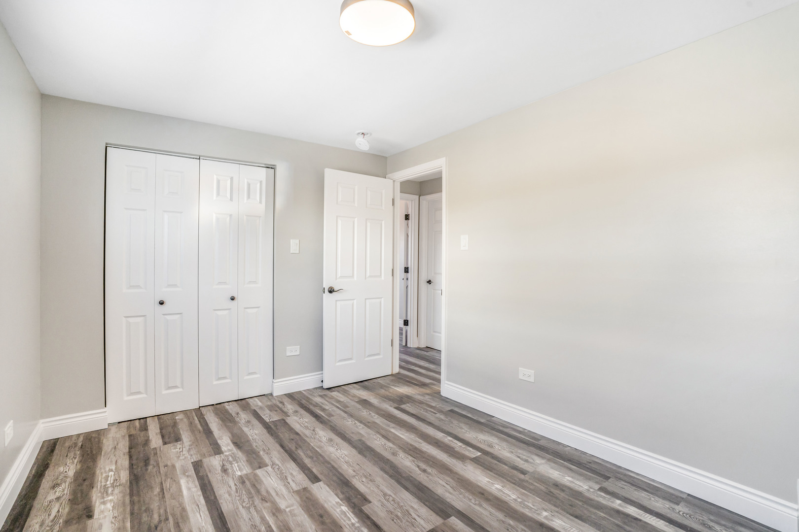 13049 South Brandon Avenue Chicago, IL 60633 - Photo 12 of 20 a view of an empty room with wooden floor