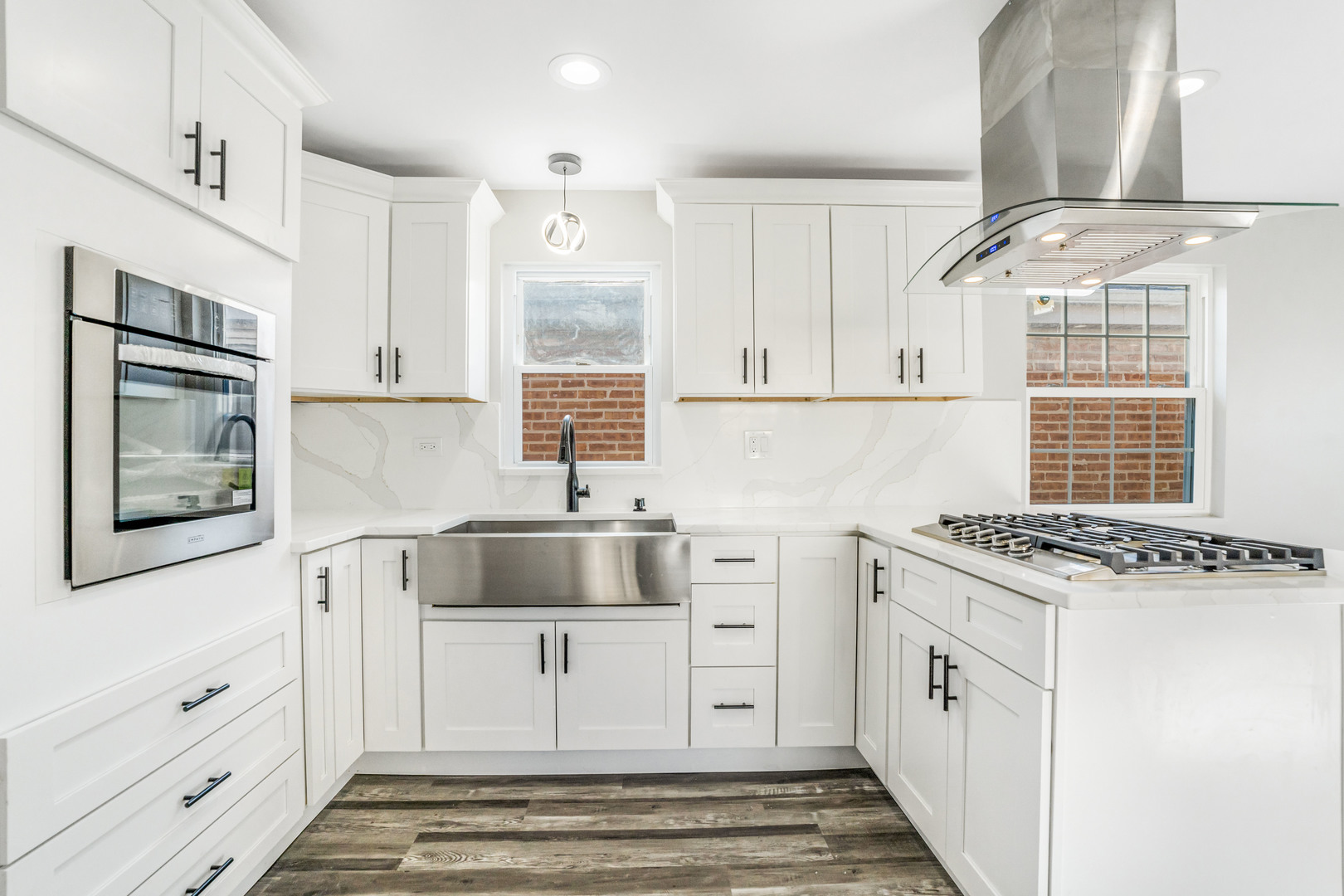 13049 South Brandon Avenue Chicago, IL 60633 - Photo 2 of 20 a kitchen with white cabinets and window