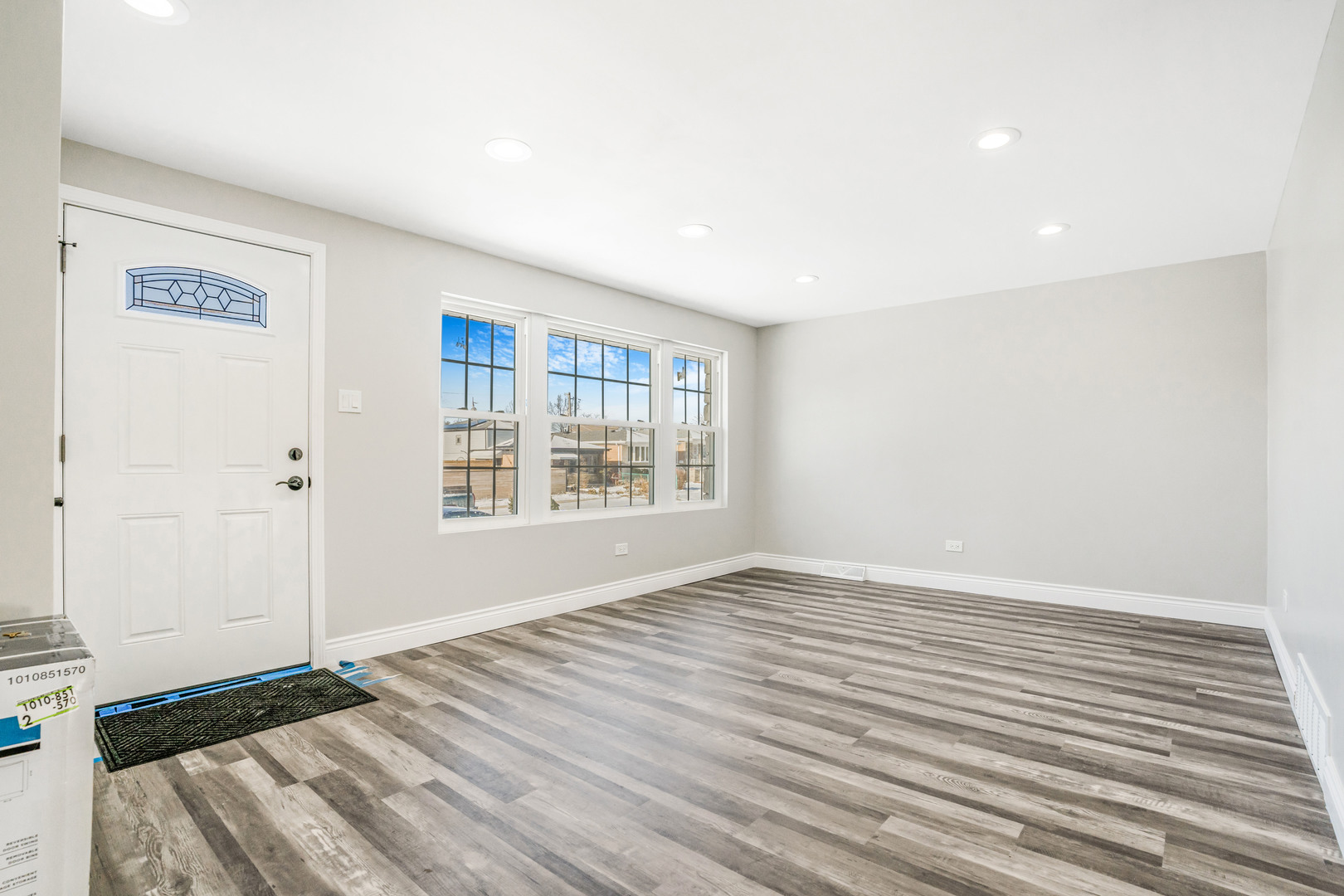 13049 South Brandon Avenue Chicago, IL 60633 - Photo 5 of 20 a view of an empty room with wooden floor and a window
