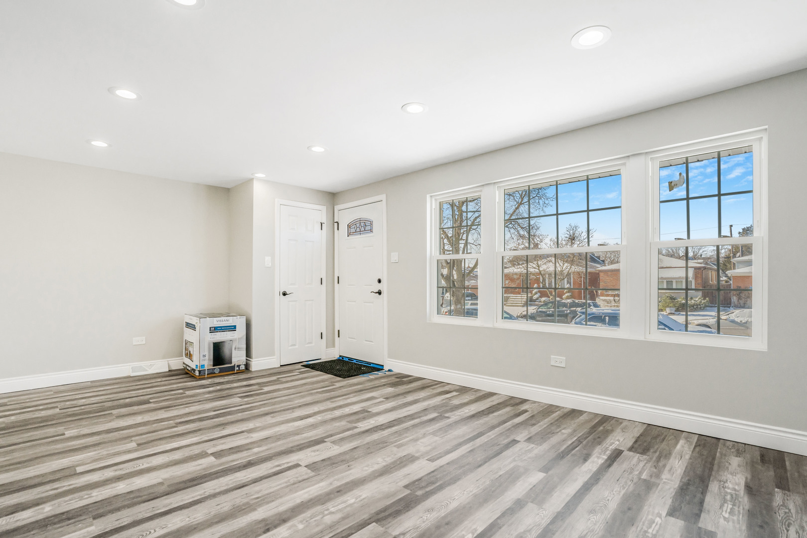 13049 South Brandon Avenue Chicago, IL 60633 - Photo 6 of 20 a view of empty room with wooden floor and fan