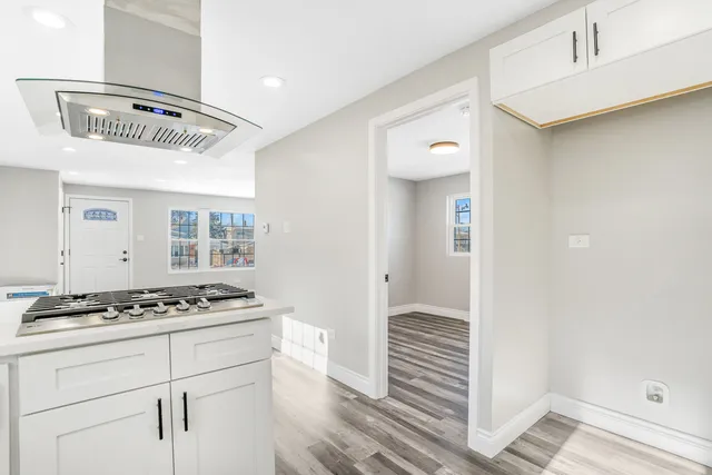 a view of kitchen cabinetry and wooden floor