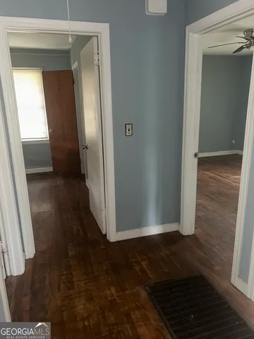 an empty room with wooden floor