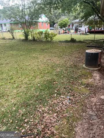 a view of a park that has large trees