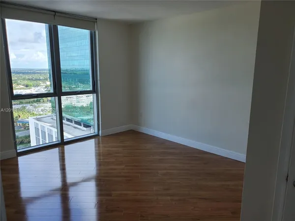 a view of wooden floor and windows in a room