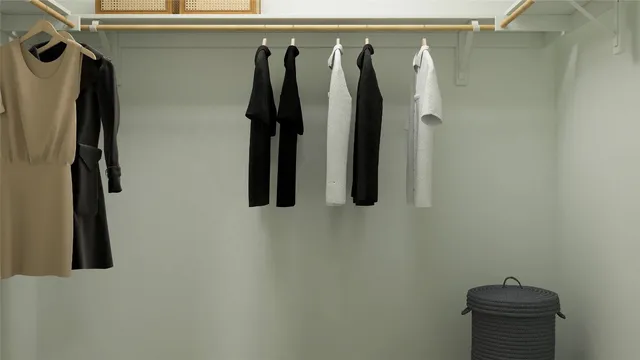 a view of walk in closet with clothes