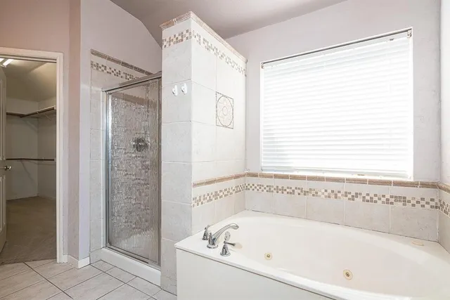 a bathroom with a bathtub and a shower