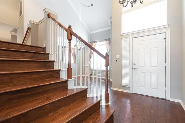 a view of entryway and hall with wooden floor