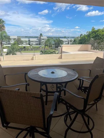 a view of a balcony with table and chairs