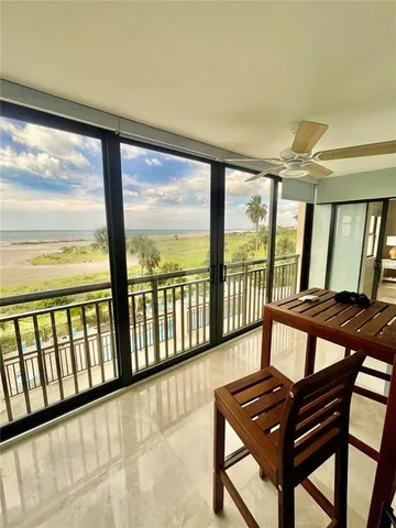 a view of a city from a balcony with furniture