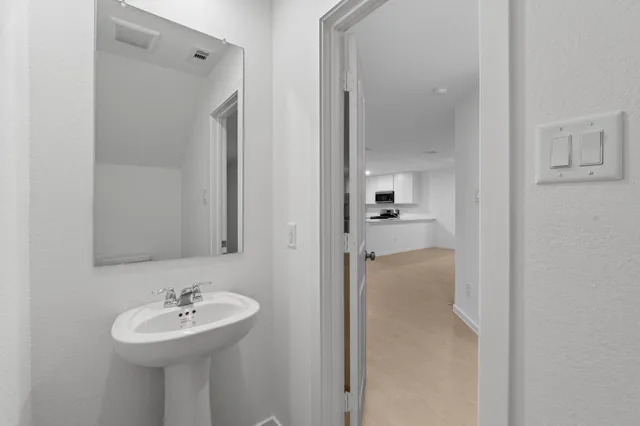 a bathroom with a sink a mirror and shower