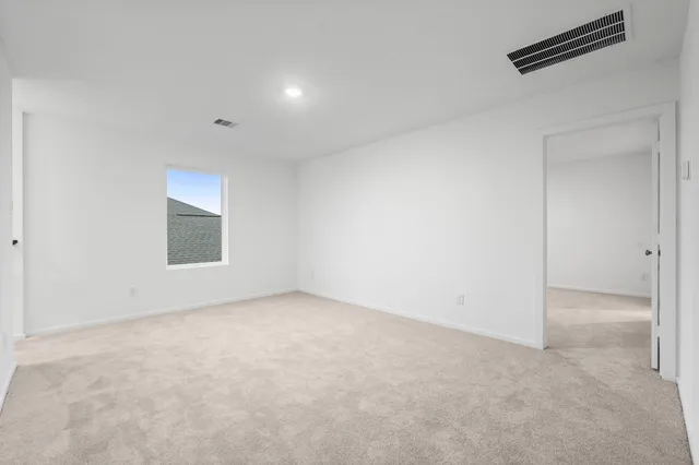 an empty room with a empty space and windows