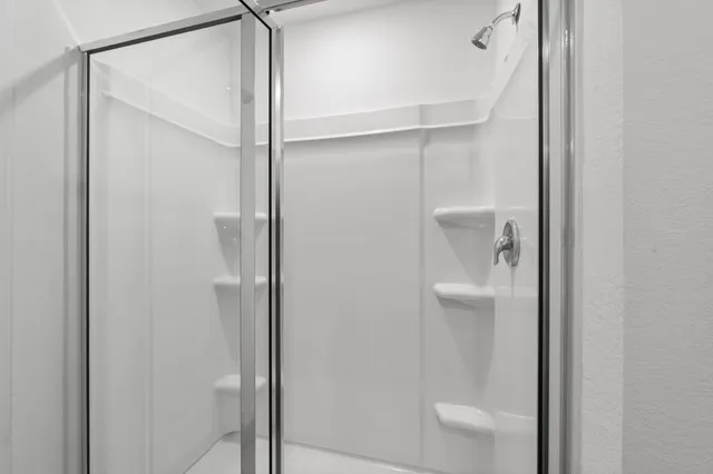 a bathroom that has a glass shower door