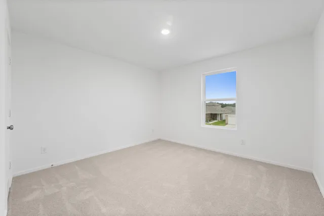 a view of an empty room and a window