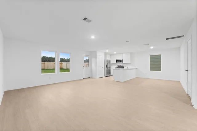 a view of a big room with closet and windows