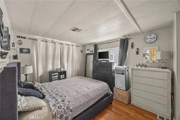 a bedroom with a bed and a television