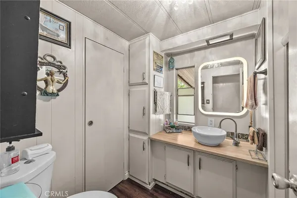 a bathroom with a sink vanity and a mirror