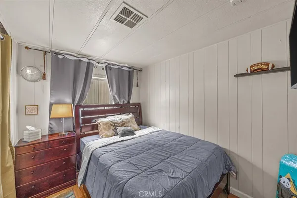 a bedroom with a bed and a mirror