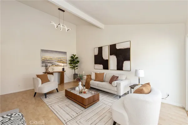 a living room with furniture and a chandelier