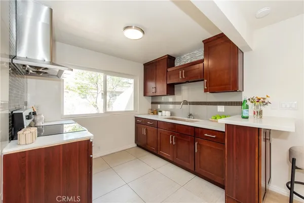a kitchen with a sink cabinets and window