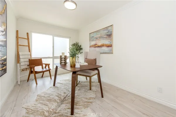 a workspace room with furniture and a potted plant