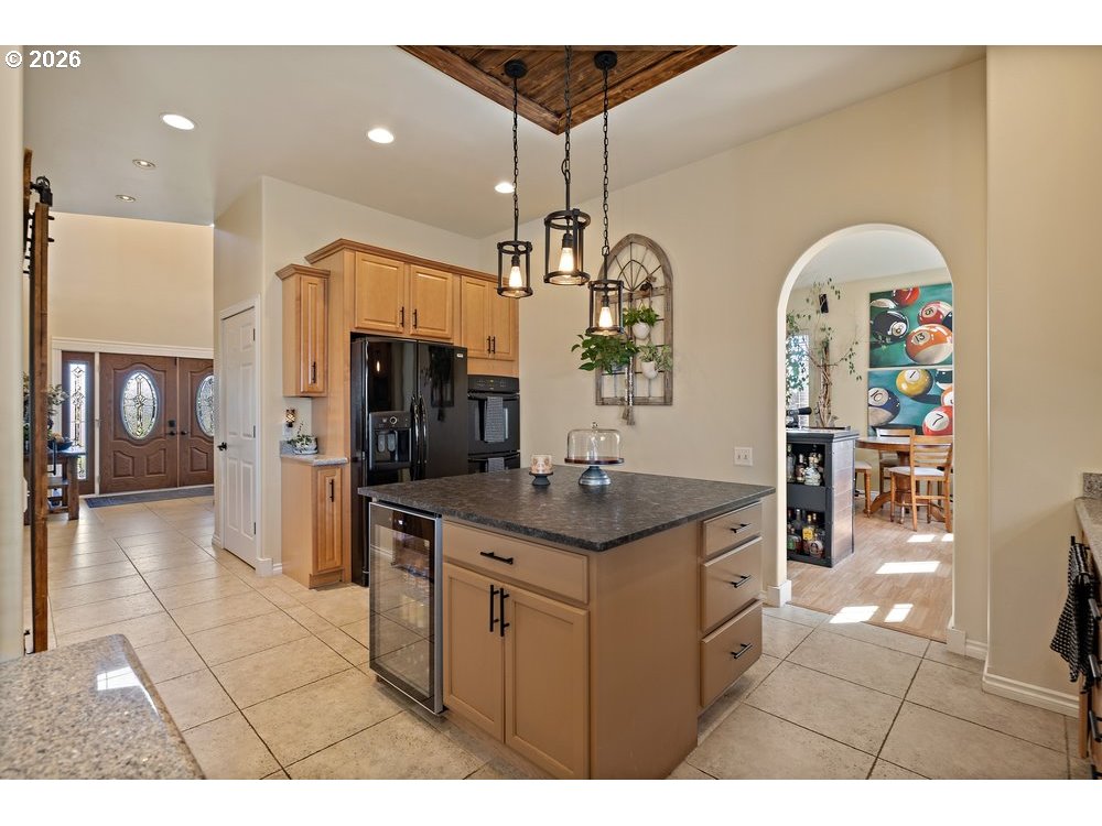 500 St Hilaire Road Yakima, WA 98901 - Photo 5 of 29 a kitchen with stainless steel appliances granite countertop a sink a stove a refrigerator a dining table and chairs