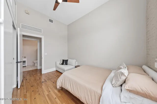 a bedroom with a bed and a mirror