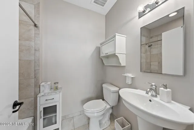 a bedroom with a bed and a large mirror