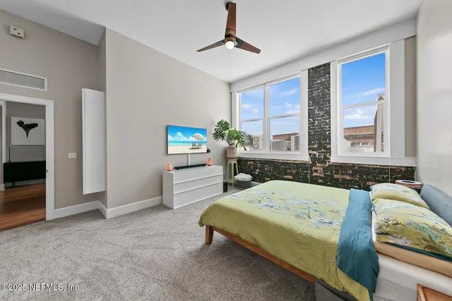 a bedroom with a bed and a tv