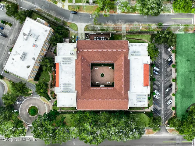 a front view of a building with a garden