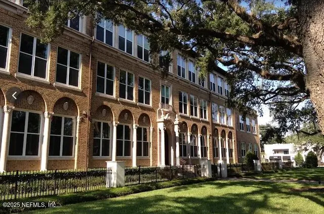 a front view of a building with garden