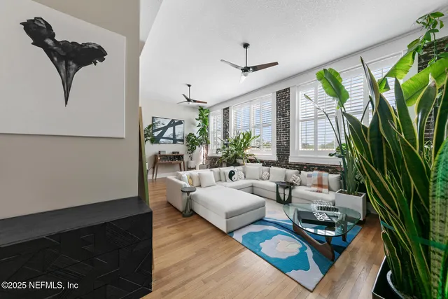 a living room with patio bathtub table and a large window