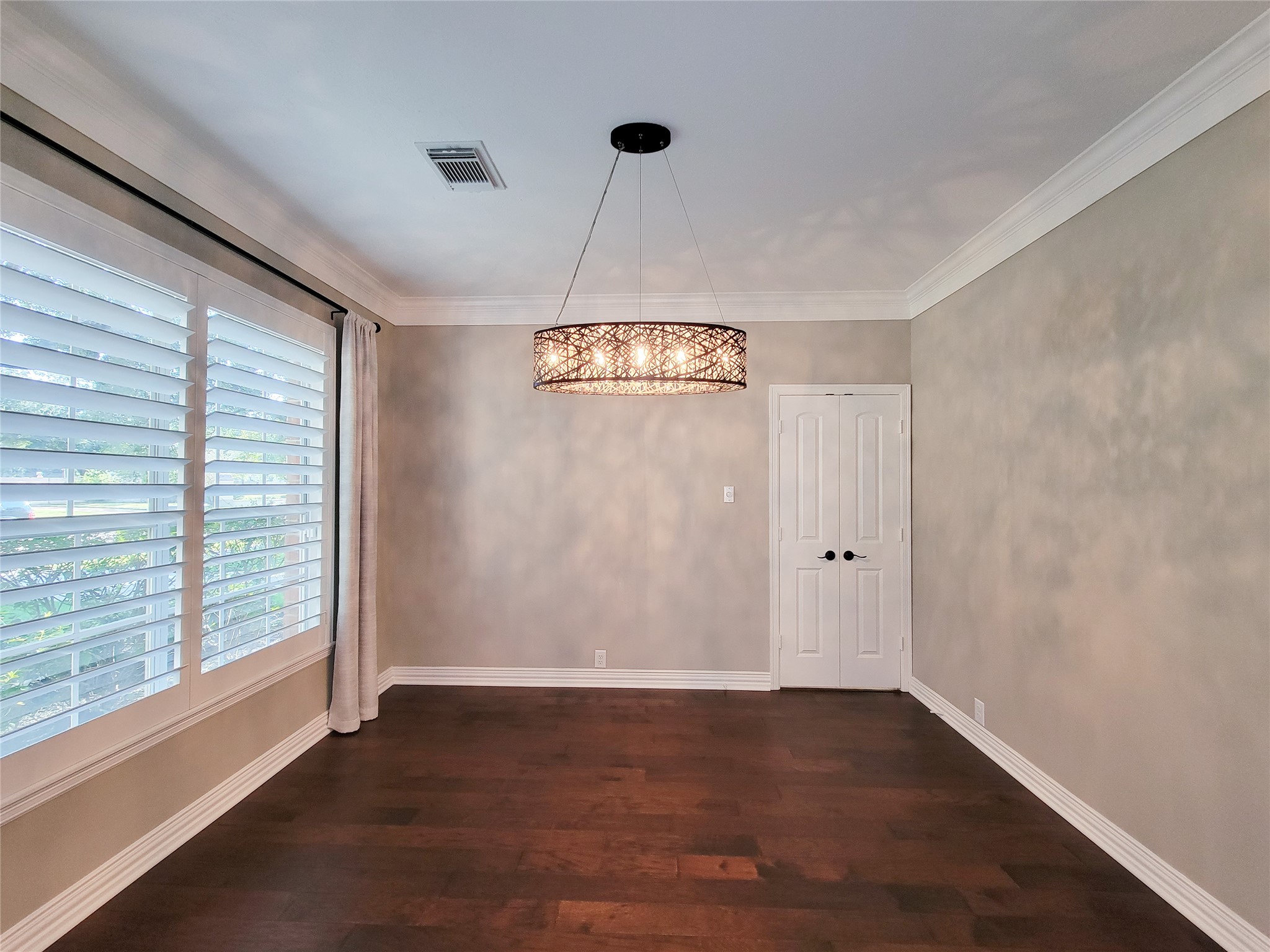5507 Evening Shore Drive Houston, TX 77041 - Photo 9 of 50 a view of an empty room with wooden floor and a window