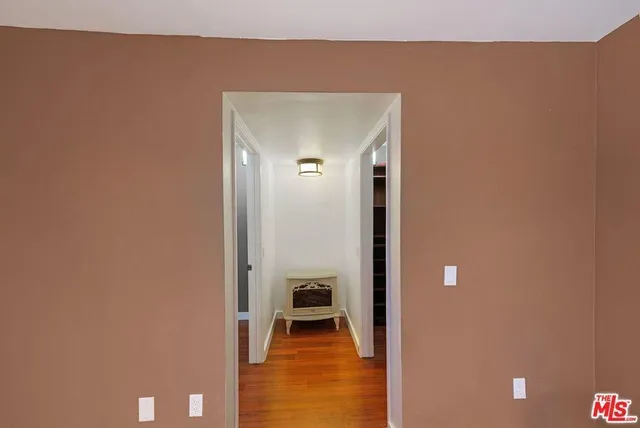 a view of a livingroom with furniture and an empty room