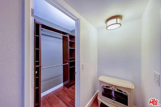 a view of an empty room and wooden floor