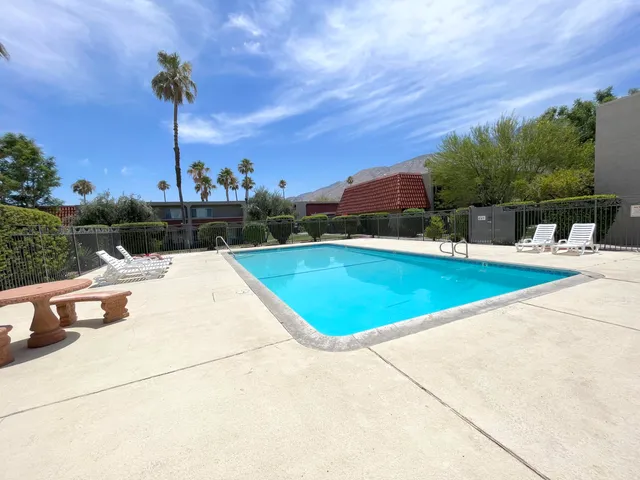 an outdoor space with pool and furniture