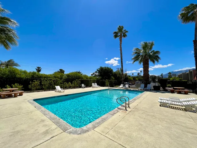 a view of a swimming pool and a yard
