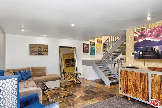 a living room with furniture and a floor to ceiling window